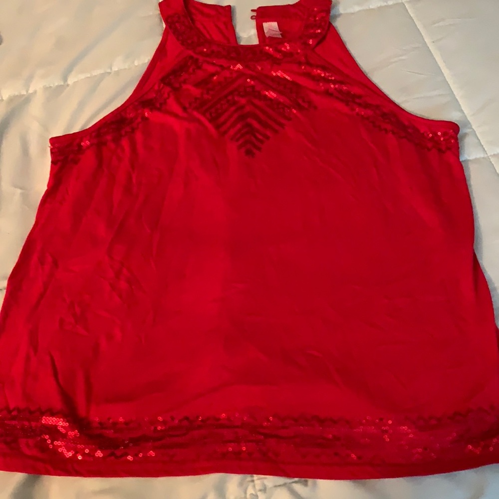 This red sleeveless blouse is adorable and holidays are around the corner